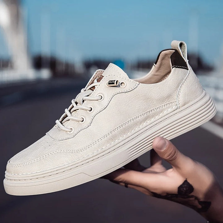 Pair of classic beige leather men's sneakers, casual & durable footwear