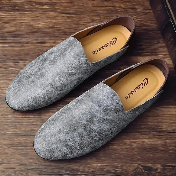 Group shot of men's slip-on loafers in brown, gray, and sand colors