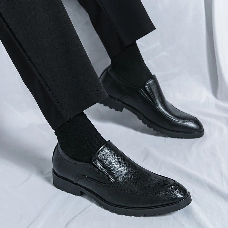 Classic men's black leather slip-on loafers, offering timeless comfort for versatile everyday fashion.