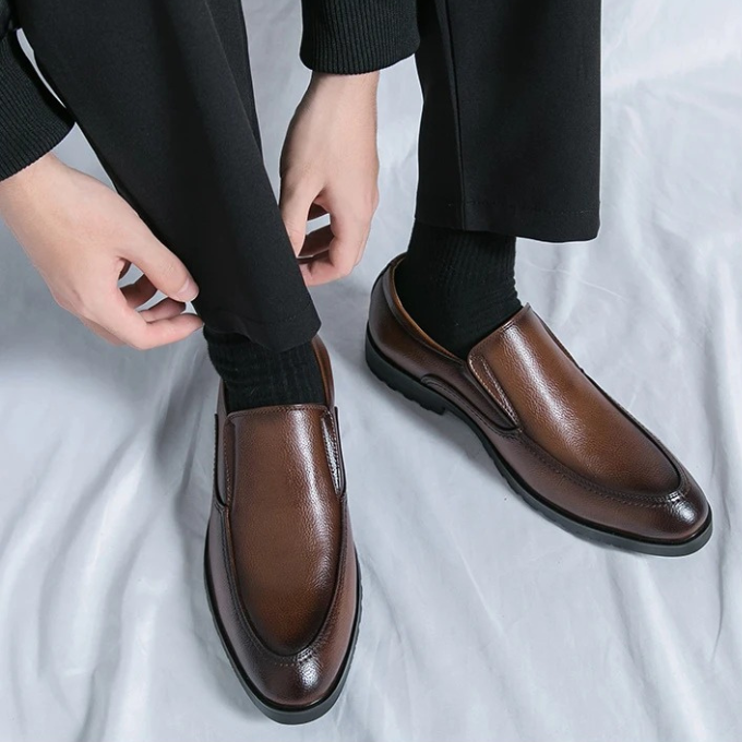 Close-up of a men's slip-on loafer showing stitched detailing and soft leather, emphasizing comfort.