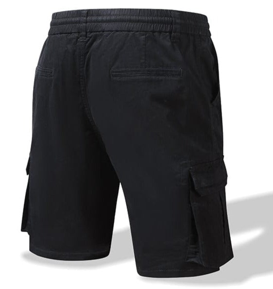 Man wearing men's casual cotton blend comfort shorts, demonstrating relaxed fit and styling.