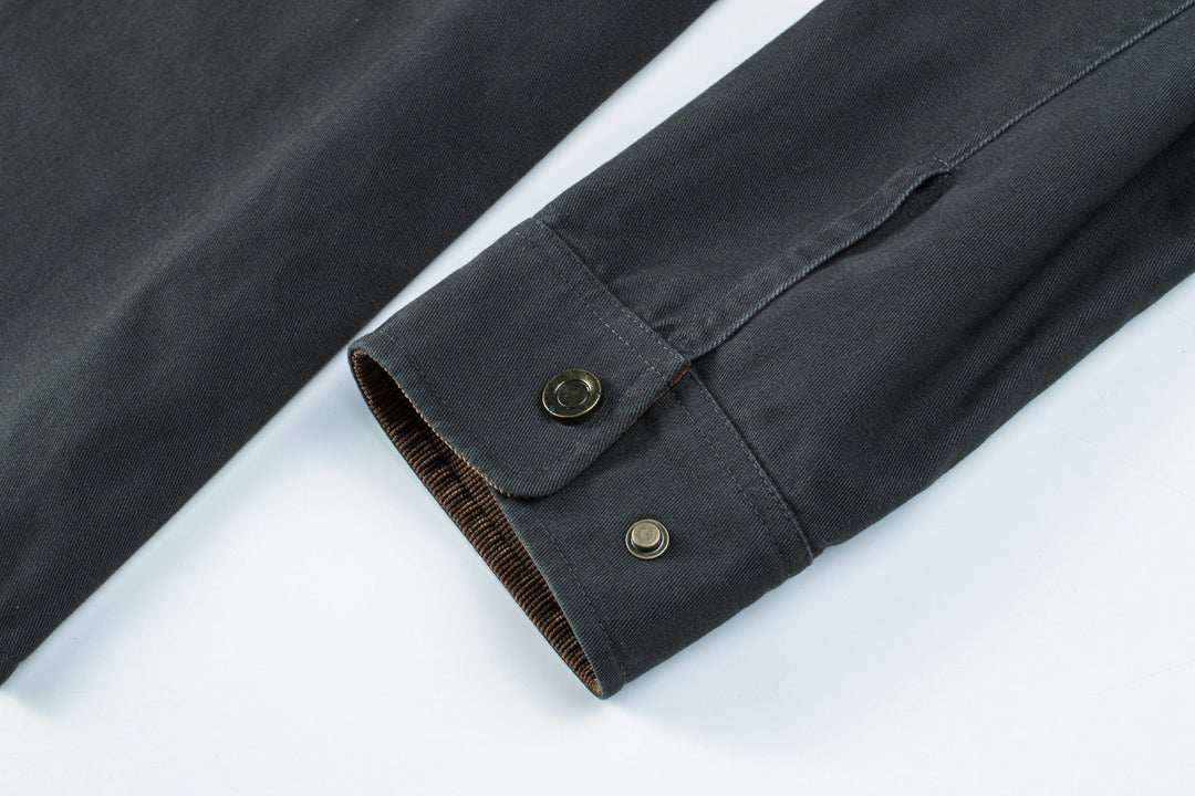 Men's fashion: close-up of stitching on a durable cotton button-up shirt jacket.