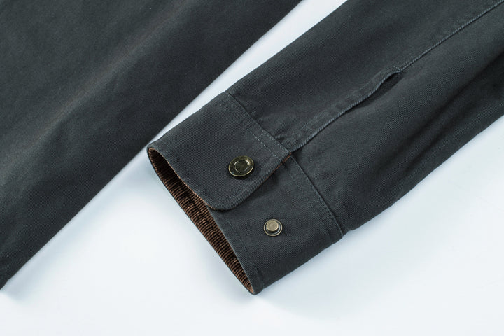 Men's fashion: close-up of stitching on a durable cotton button-up shirt jacket.
