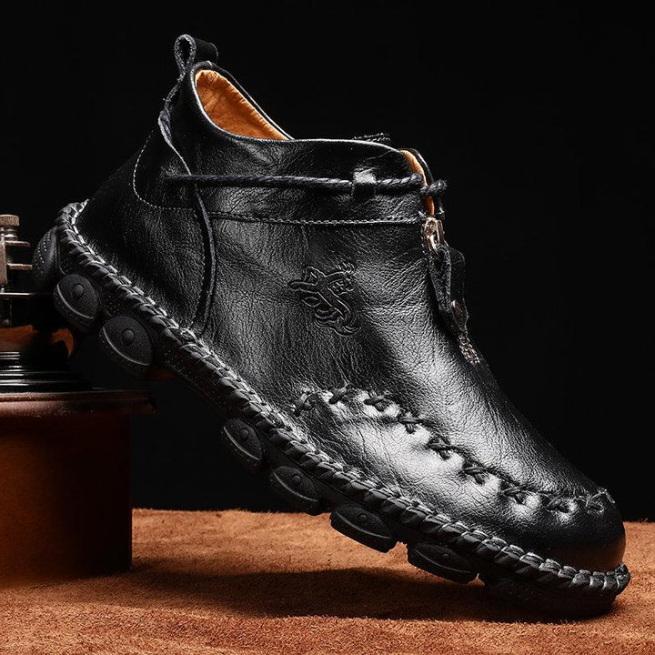 Close-up of the textured leather on men's hand-stitched ankle boots, perfect for fall winter style.