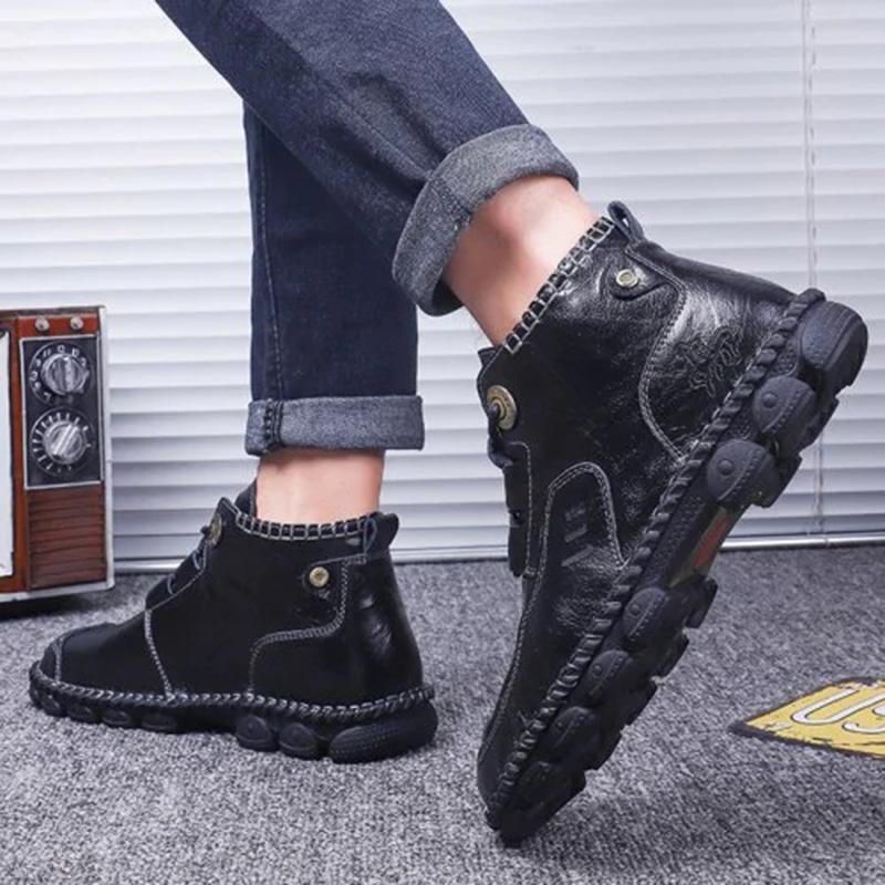 A stack of men's different colored hand stitched leather boots, showcasing variety and quality