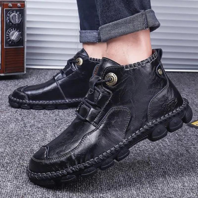 Pair of men's casual leather boots from a side angle, highlighting the sturdy sole and quality material
