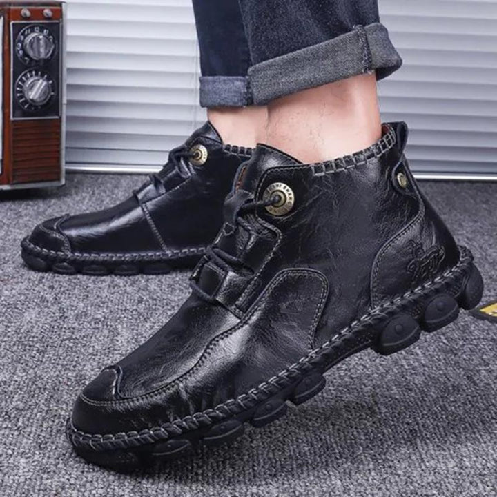 Pair of men's casual leather boots from a side angle, highlighting the sturdy sole and quality material
