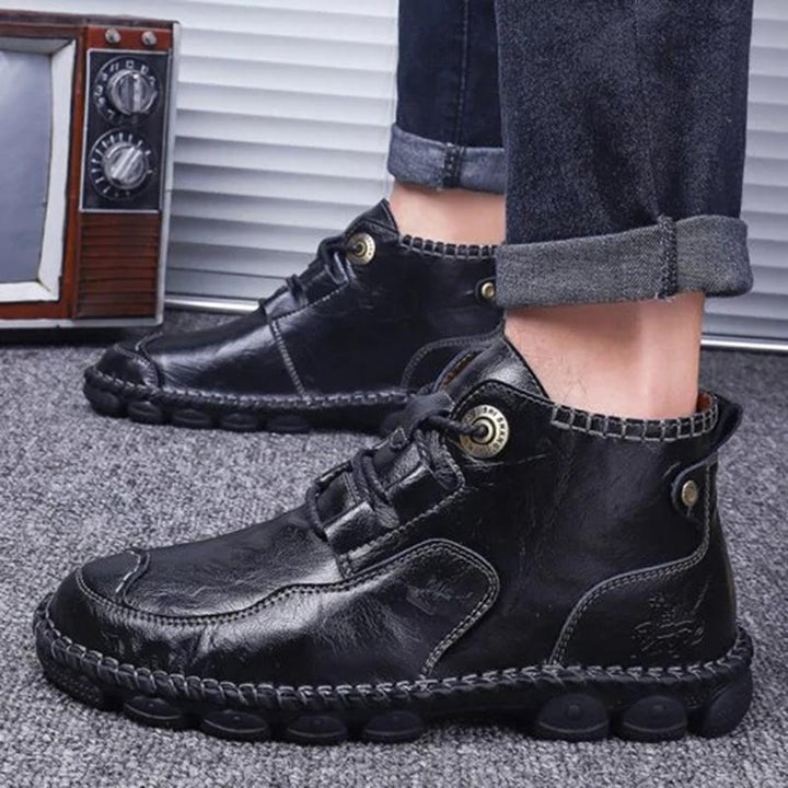 Front view of men's hand stitched leather boots, emphasizing the comfortable round toe and classic style