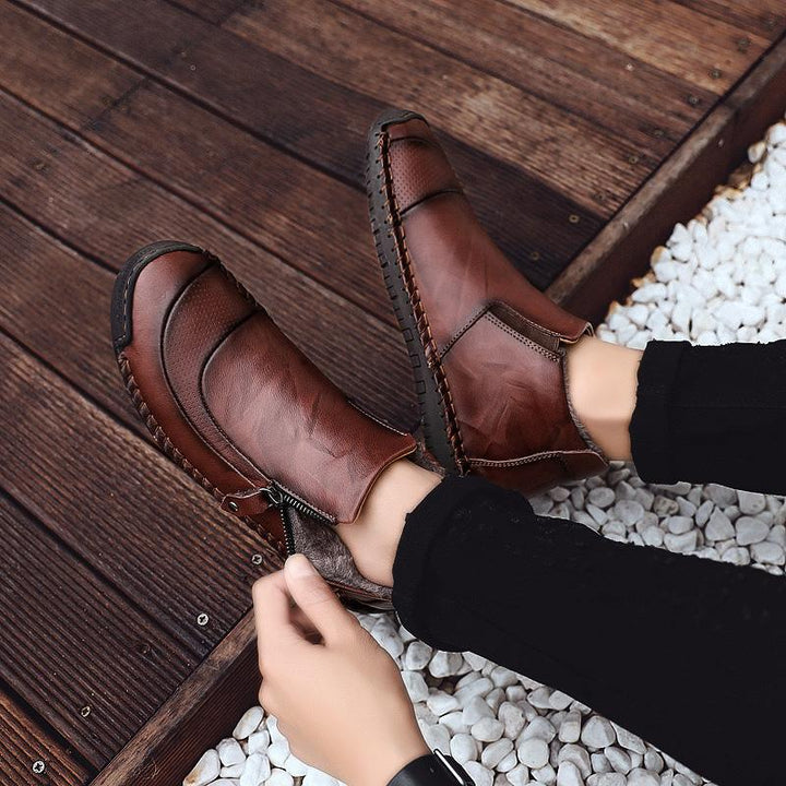 Men's casual shoes: Handcrafted Leather Ankle Boots on a neutral background