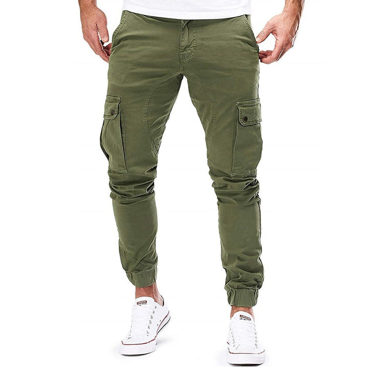 Folded stack of men's cargo trousers in various colors: green, beige, and navy