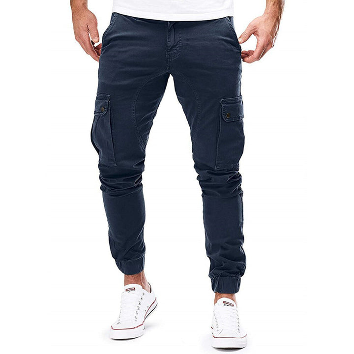 Man sitting wearing olive green casual cargo trousers, showcasing flexibility & comfort