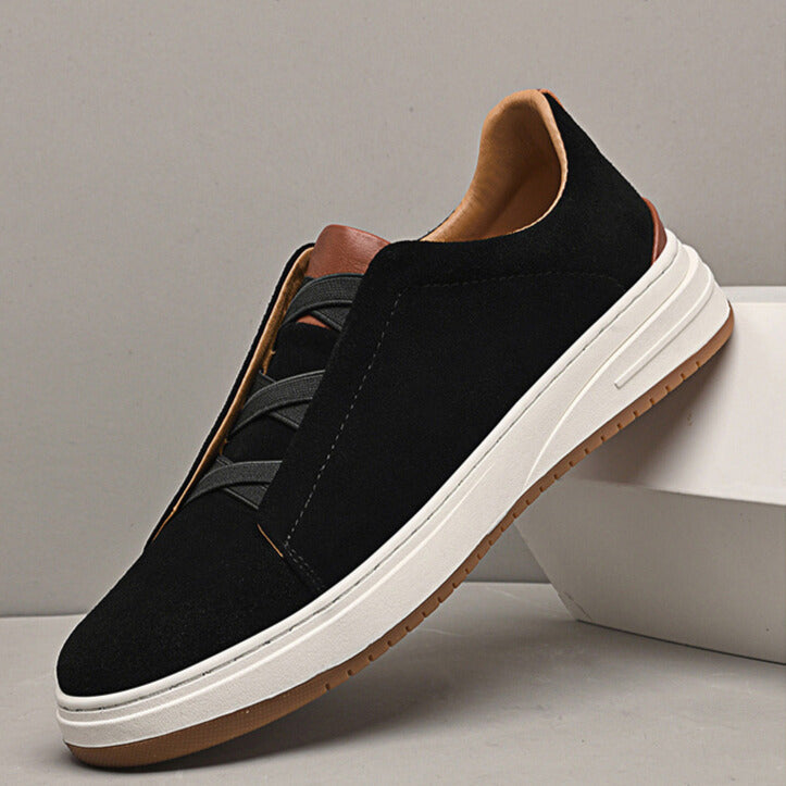 Black suede slip-on sneakers for men, featuring a sleek design and comfortable rubber sole.