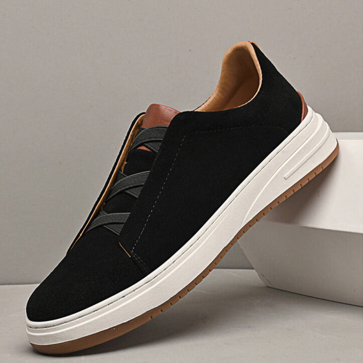 Black suede slip-on sneakers for men, featuring a sleek design and comfortable rubber sole.