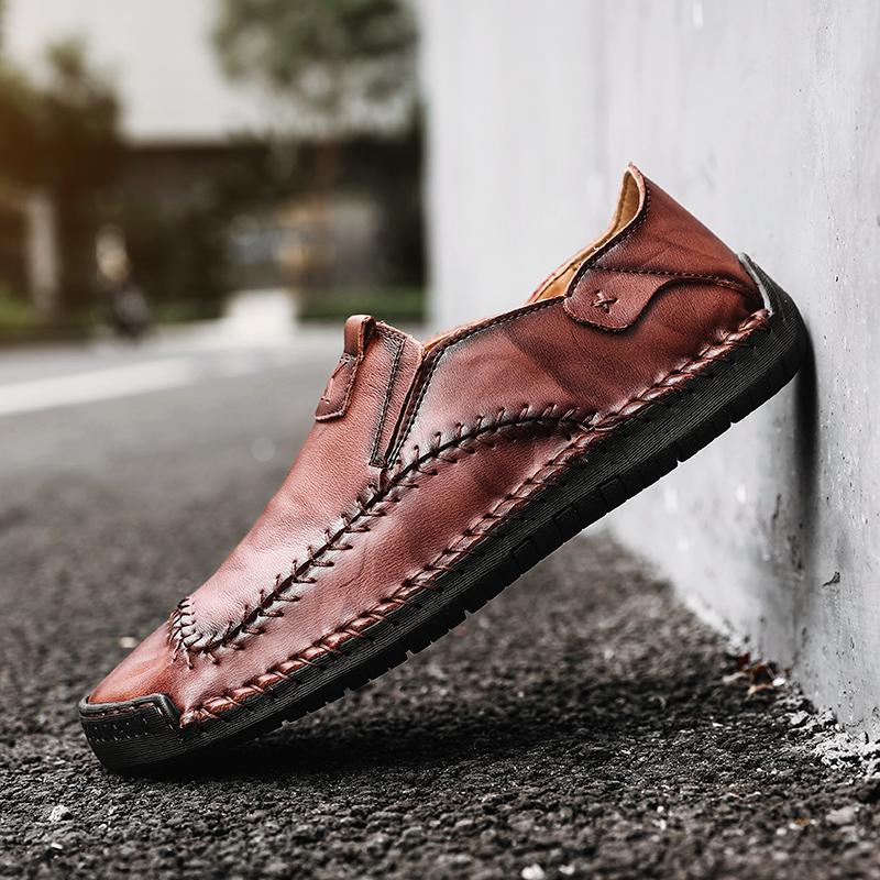 Detail of the genuine leather texture on men's hand-stitched casual shoes with a soft sole