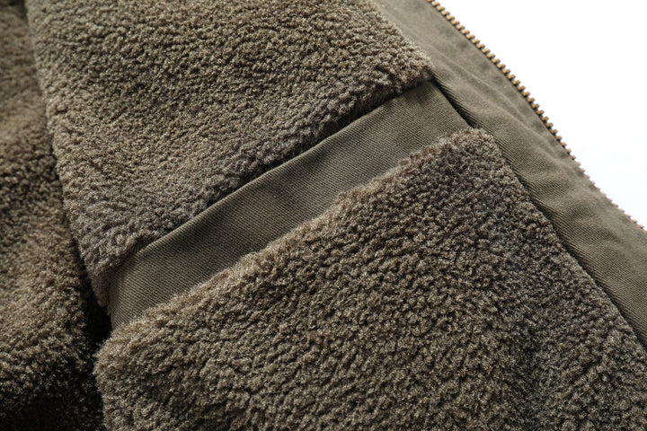 Folded men's lightweight outdoor jacket, showcasing its compact nature for travel or storage.