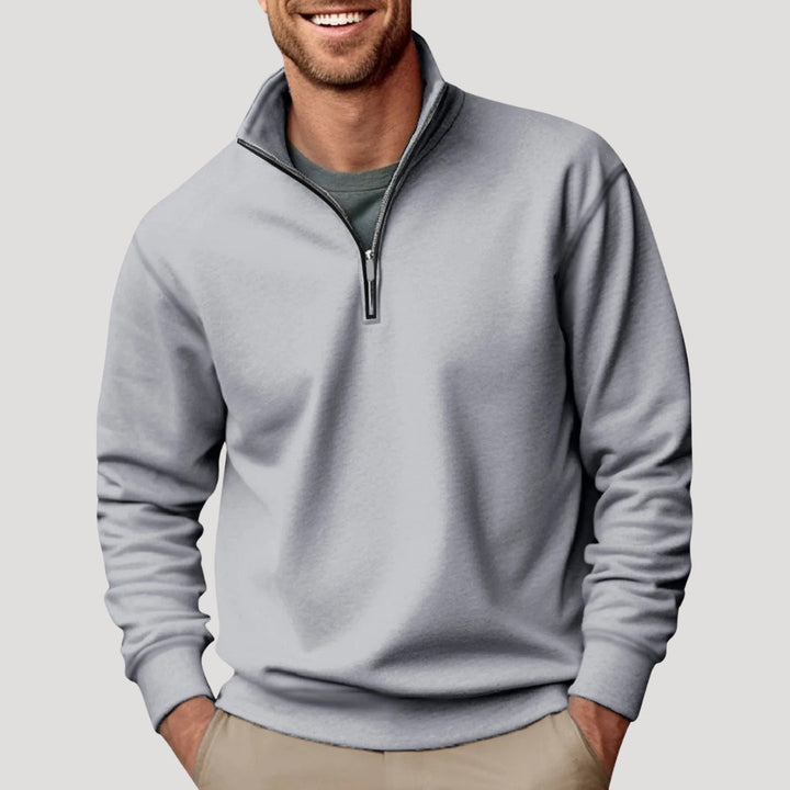 Stylish quarter-zip men's sweatshirt in an autumn setting, comfortable long sleeve