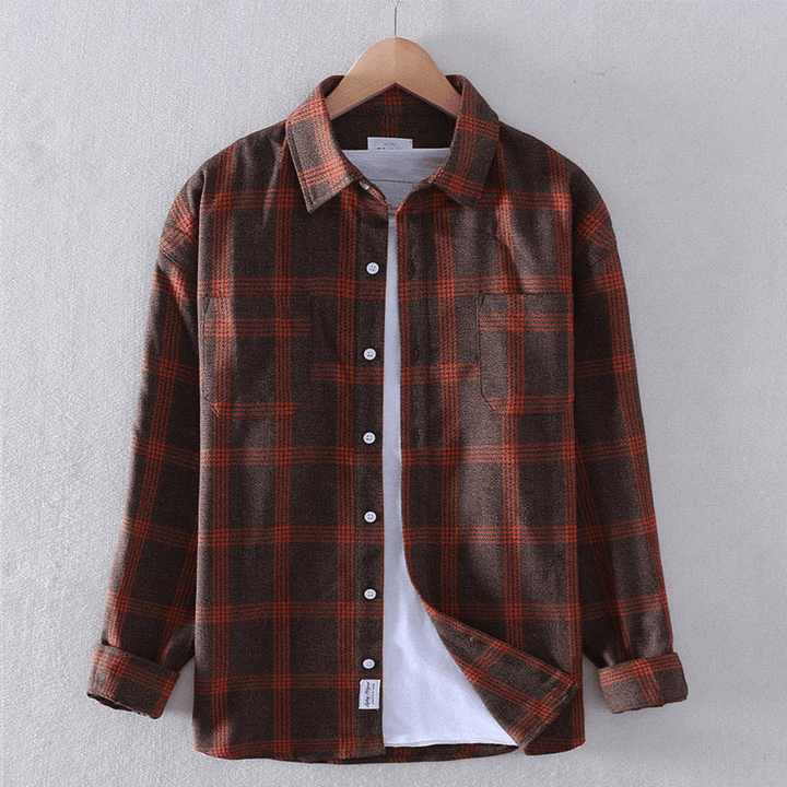 Close-up of a man's casual checkered long-sleeve shirt, highlighting the fabric and button details. Men's plaid.