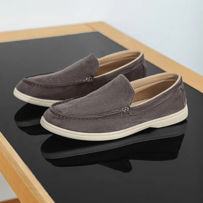 Side profile of men's slip-on suede-look loafers, emphasizing the sleek silhouette.