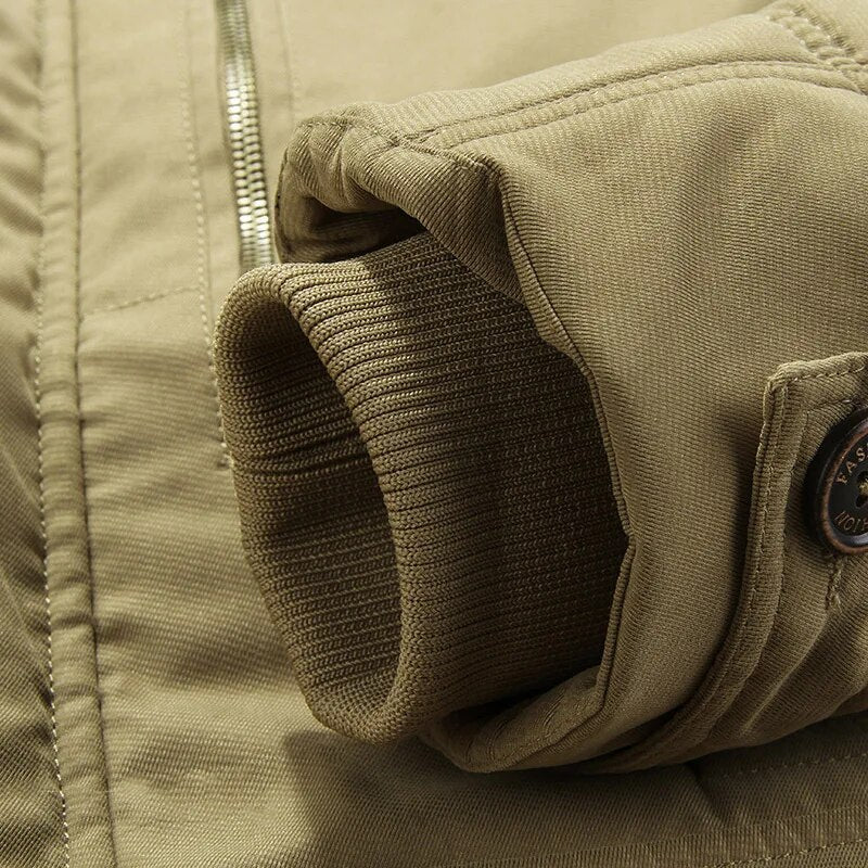 Close-up of the sturdy zipper and snap button closure on the men's corduroy winter jacket
