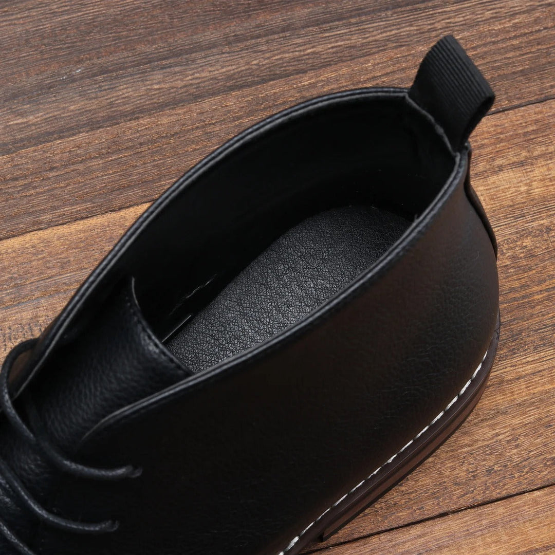 Close-up of men's black chukka boots, highlighting quality material and design.
