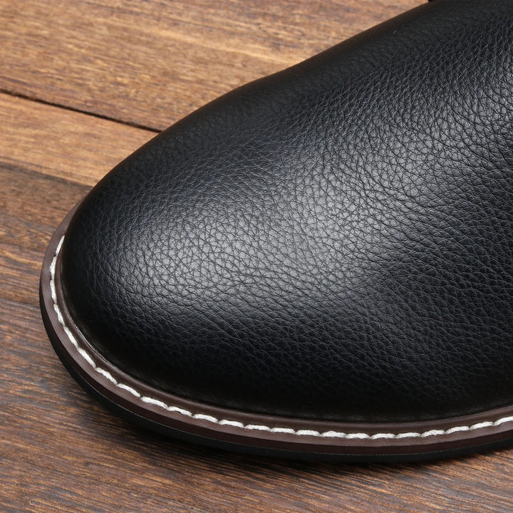 Side view of men's black chukka boots, showcasing the ankle boot silhouette.