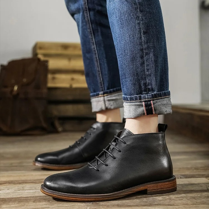 Close-up of the stitching and craftsmanship on men's leather chukka boots.