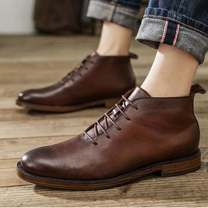 Close-up of the polished toe of men's leather dress boots, high shine.