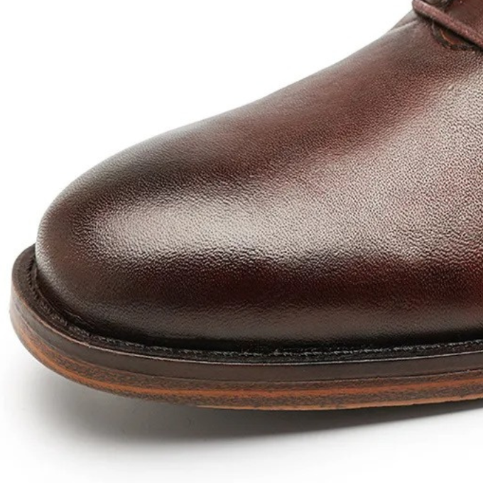 Side profile of men's black leather boots, ideal for business or events.