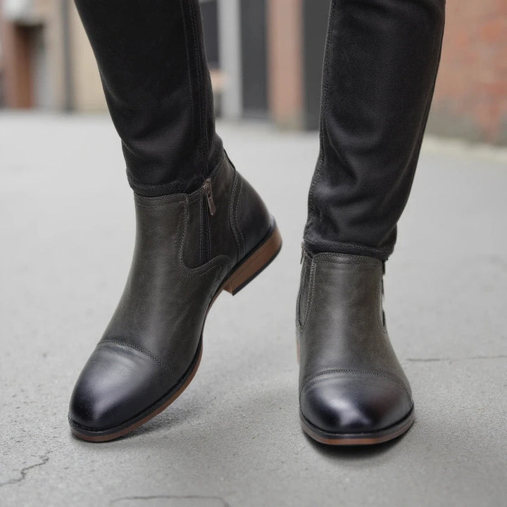 Stylish men's black Chelsea boots with an accessible side-zip, designed for both durability and fashion.