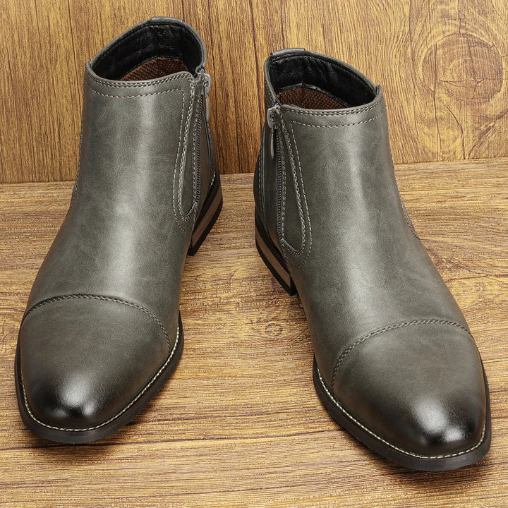 Side profile of men's black Chelsea boots with a prominent side-zip, ideal for sophisticated men's footwear.