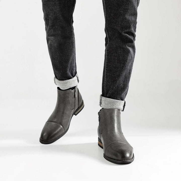 Pair of brown men's Chelsea boots with side-zips, a timeless addition to any men's footwear collection.