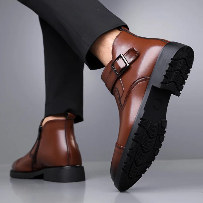 Close-up of men's sleek black Chelsea dress boots with elastic side panels, professional footwear.