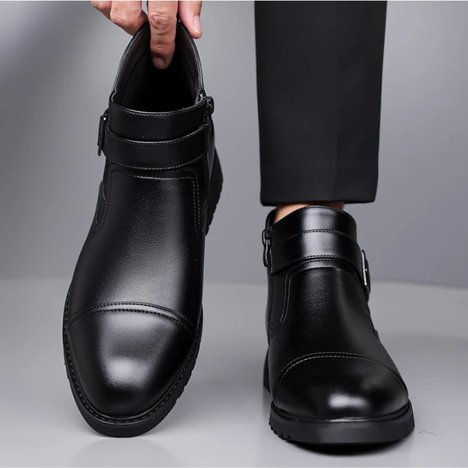 Front view of men's classic black Chelsea dress boots, emphasizing clean lines and sharp design.