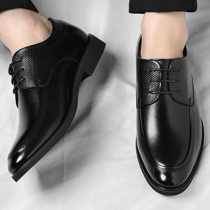 Classic men's leather dress shoes on a light background, highlighting their versatile style & quality