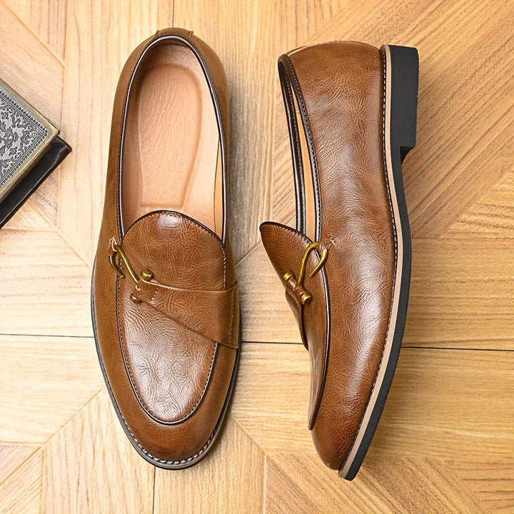 Top-down view of men's classic leather loafers in black, showcasing their elegant silhouette