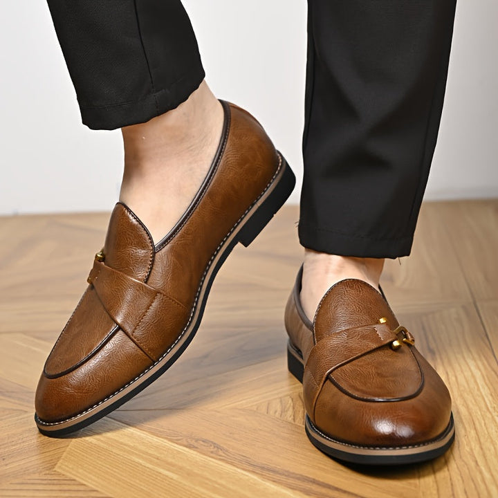 Detail shot of the stitching on a men's brown leather loafer, emphasizing quality footwear