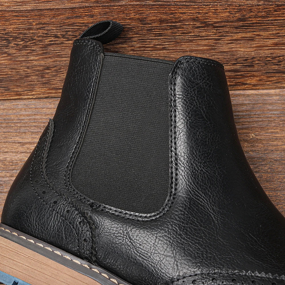 Stylish black leather Chelsea boots for men, offering a comfortable slip-on fit & timeless appeal.