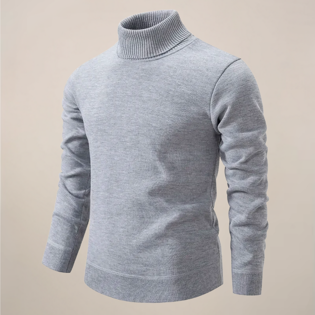 Detailed close-up of the knit texture on a men's long sleeve turtleneck sweater in navy blue.