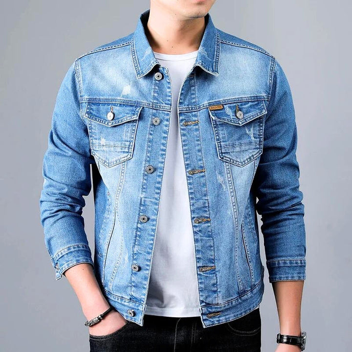 View of the back of a men's gray tapered denim jacket, highlighting the modern fit