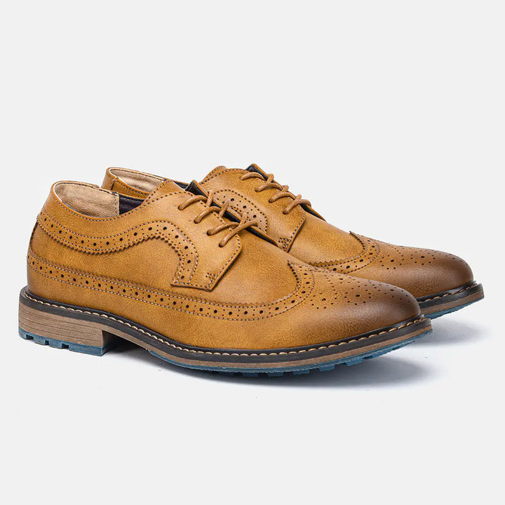 Close-up of the intricate brogue detailing on men's black leather dress shoes, elegant formal footwear