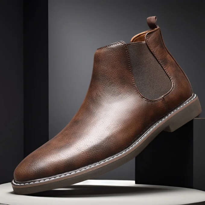 Pair of men's black leather Chelsea boots, front view, highlighting polished finish.