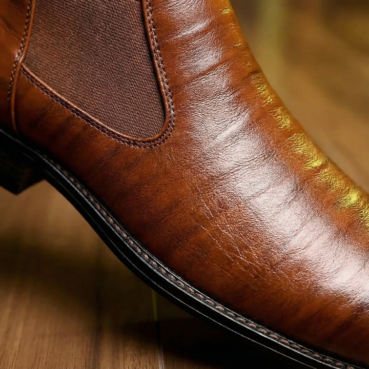 Front view of men's elegant black leather Chelsea boots, versatile footwear