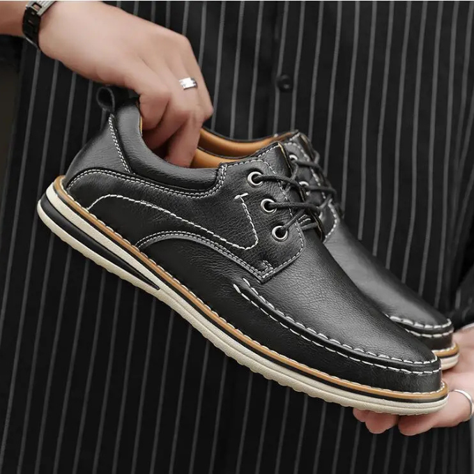 Detailed shot of the moc toe on gray leather men's Oxford shoes