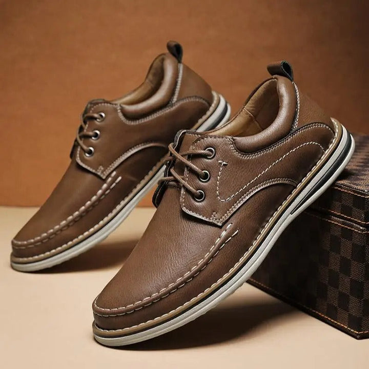Close-up of gray leather moc toe Oxford shoes, showcasing stitch detail