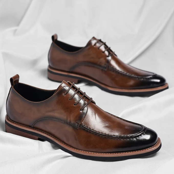 Luxury men's Oxford shoes in rich brown leather, showcasing fine craftsmanship & timeless design.