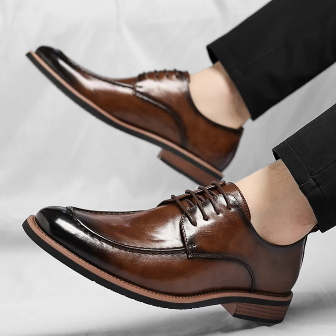 Close-up of men's black Oxford dress shoes, highlighting the premium leather texture & polished finish.