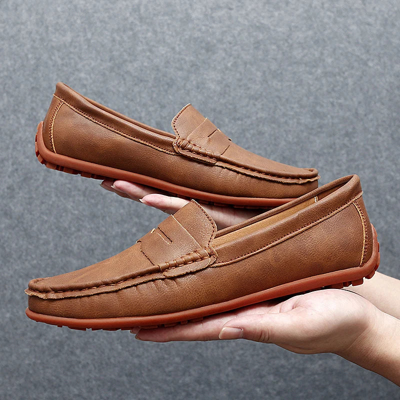 Men's classic brown leather penny loafers, perfect for dress or casual wear.