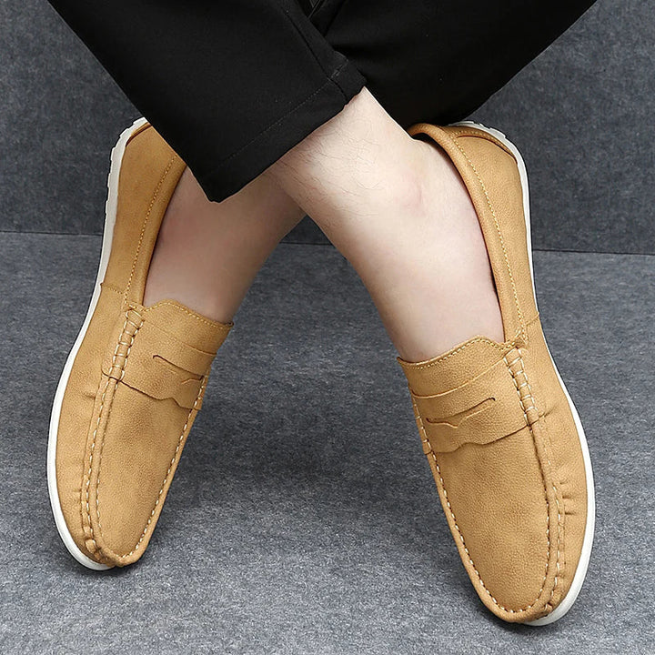 High-quality men's leather penny loafers in a rich chestnut color.