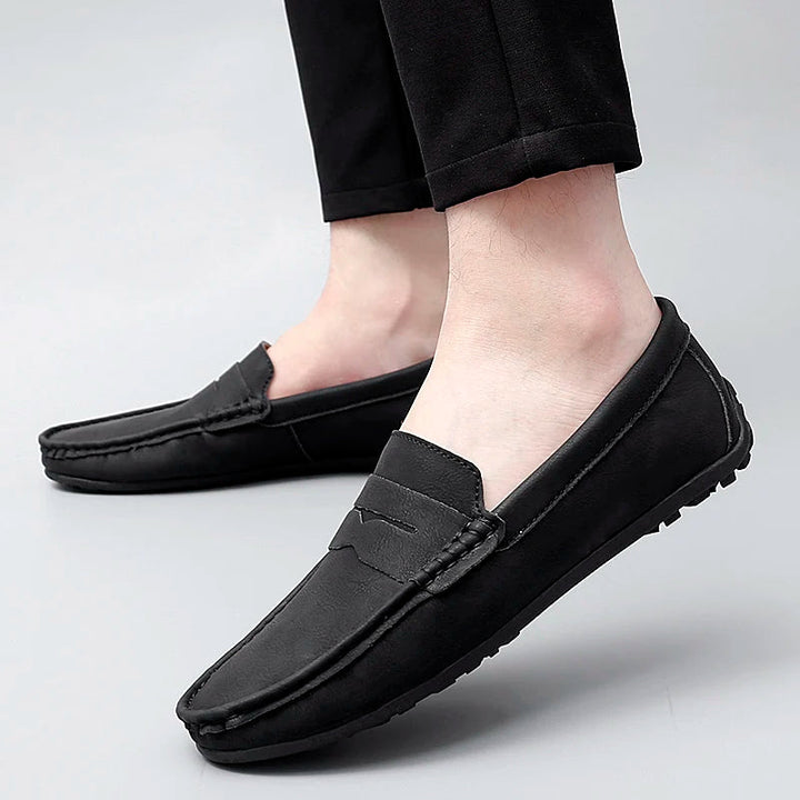 Stylish men's leather penny loafers in a rich, deep burgundy hue.