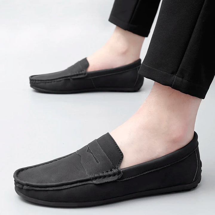 Refined men's leather slip-on shoes, showcasing the timeless penny loafer style.